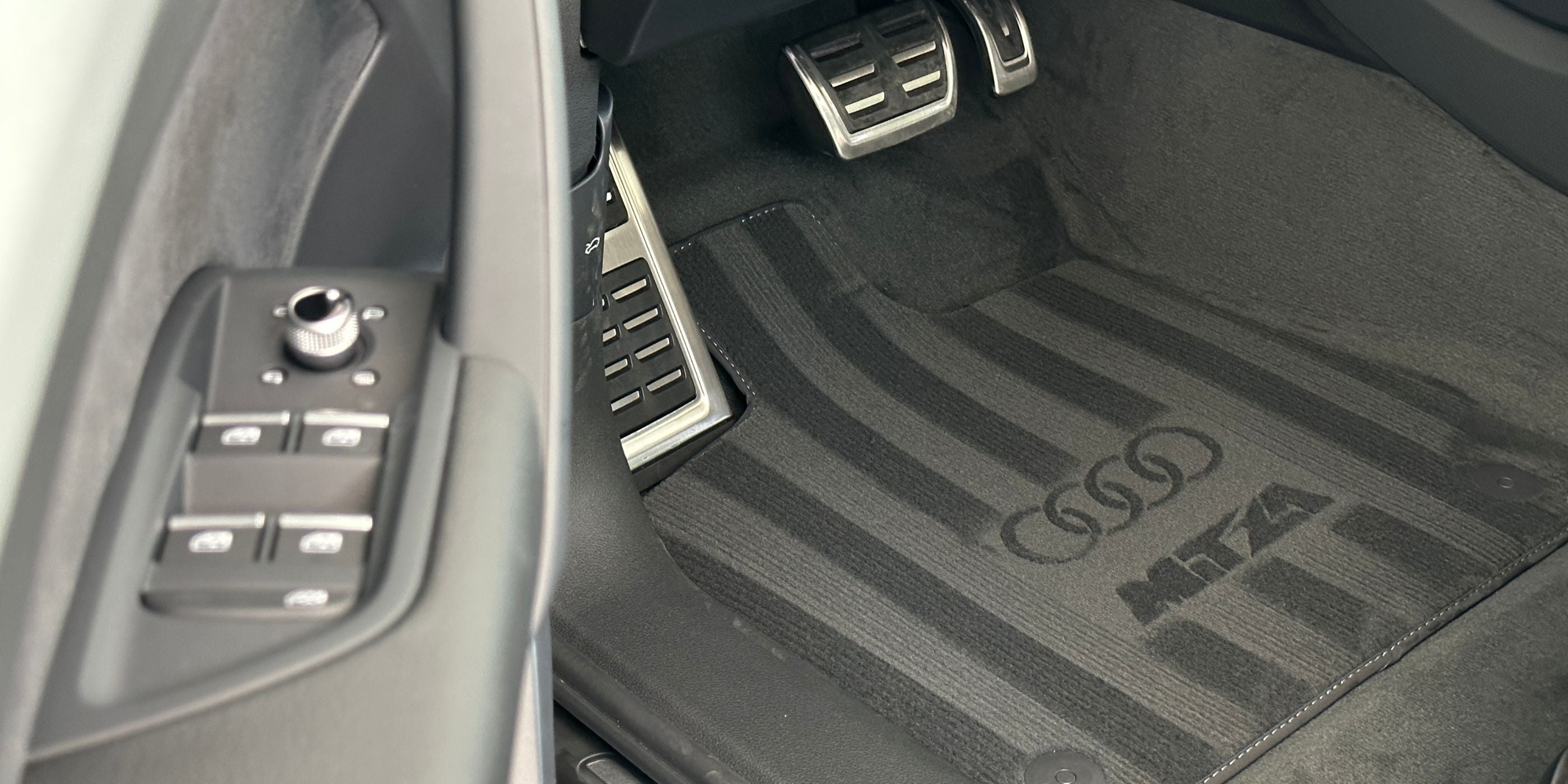 audi logo made on the car carpet with the stencil car brand book